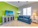 Relaxing living room with coastal-inspired decor, hardwood flooring, and a flat-screen TV at 803 Gladiolus St, Anna Maria, FL 34216