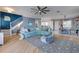 Bright, open-plan living room with hardwood floors, stairs, a ceiling fan, and open to the dining area at 803 Gladiolus St, Anna Maria, FL 34216