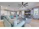 Airy living room featuring an open plan to the kitchen and dining room and a comfy sectional sofa at 803 Gladiolus St, Anna Maria, FL 34216