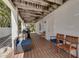 Covered patio area with an outdoor grill, seating and wood flooring at 803 Gladiolus St, Anna Maria, FL 34216