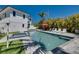 Backyard pool, hot tub, patio and lush tropical plants behind the home at 803 Gladiolus St, Anna Maria, FL 34216