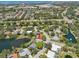 Overhead view of the property in a residential area featuring lakes, mature trees, and neighborhood amenities at 8146 Shadow Pine Way, Sarasota, FL 34238
