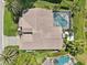 Overhead shot of a single Gathering home with a screened-in pool, manicured lawns and tropical landscaping at 8146 Shadow Pine Way, Sarasota, FL 34238