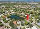 Aerial shot of a lakeside community featuring mature trees, well-maintained homes, and water views at 8146 Shadow Pine Way, Sarasota, FL 34238