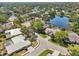 Aerial shot showcasing the home's location in a tranquil neighborhood with lake views and mature trees at 8146 Shadow Pine Way, Sarasota, FL 34238