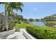 Beautiful water view from the home's lush backyard. The serene scenery overlooks the neighborhood lake at 8146 Shadow Pine Way, Sarasota, FL 34238