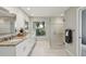 Bright bathroom features double sinks, granite countertops, and glass shower with ample natural light at 8146 Shadow Pine Way, Sarasota, FL 34238