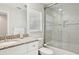 Bright bathroom featuring a granite countertop, white cabinets, and a glass-enclosed shower at 8146 Shadow Pine Way, Sarasota, FL 34238