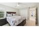 Neutral bedroom features a ceiling fan, a closet for storage, and a comfortable bed at 8146 Shadow Pine Way, Sarasota, FL 34238
