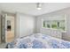 Comfortable bedroom with a ceiling fan, large closet, and a view from the window at 8146 Shadow Pine Way, Sarasota, FL 34238