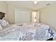 Cozy bedroom with ceiling fan, closet, and neutral decor at 8146 Shadow Pine Way, Sarasota, FL 34238