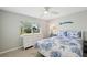 Charming bedroom with a coastal theme, white furniture, and a bright window view at 8146 Shadow Pine Way, Sarasota, FL 34238