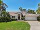 Beautiful one-story home boasts mature landscaping, a lush green lawn, and a two-car garage at 8146 Shadow Pine Way, Sarasota, FL 34238