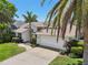 Charming single-Gathering home features a well-manicured lawn, mature palm trees, and a paved driveway at 8146 Shadow Pine Way, Sarasota, FL 34238