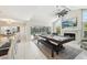 Bright game room featuring a pool table, fireplace, and access to the screened-in pool area at 8146 Shadow Pine Way, Sarasota, FL 34238