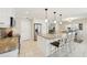 Well-lit kitchen with white cabinetry, granite countertops, stainless steel appliances, and a breakfast bar at 8146 Shadow Pine Way, Sarasota, FL 34238