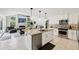 Kitchen features a granite island, stainless steel appliances, and an open concept design at 8146 Shadow Pine Way, Sarasota, FL 34238