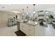 Open kitchen boasts granite island, stainless steel appliances, and adjacent dining and living spaces at 8146 Shadow Pine Way, Sarasota, FL 34238