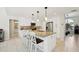 Bright kitchen with white cabinets, granite counters, stainless steel appliances, and a central island at 8146 Shadow Pine Way, Sarasota, FL 34238
