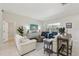 Bright living room with tile floors, modern furniture, and sliding glass doors to the pool at 8146 Shadow Pine Way, Sarasota, FL 34238