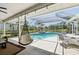 Inviting screened-in pool area featuring a covered patio, poolside seating, and a view of the lush landscape at 8146 Shadow Pine Way, Sarasota, FL 34238