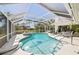 Aerial view of a private pool and spa encased in a screened enclosure in the home's backyard at 8146 Shadow Pine Way, Sarasota, FL 34238