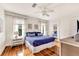 Bright bedroom featuring hardwood floors, white walls, ceiling fan, and a comfy bed at 829 Bayshore Blvd, Tampa, FL 33606