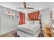 Bedroom with a unique headboard, light colored walls, wood floors, and coral colored curtains at 829 Bayshore Blvd, Tampa, FL 33606