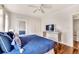 Cozy bedroom with hardwood floors, white walls, closet, and a bed with blue bedding at 829 Bayshore Blvd, Tampa, FL 33606