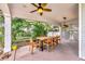 Relaxing covered patio with a dining table, surrounded by lush greenery and a serene atmosphere at 829 Bayshore Blvd, Tampa, FL 33606