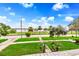 Lush front yard with manicured lawn, mature trees, and a glimpse of the bay at 829 Bayshore Blvd, Tampa, FL 33606