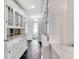 Bright hallway with hardwood floors and custom cabinets that leads to a bathroom at 829 Bayshore Blvd, Tampa, FL 33606