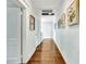 Bright hallway with hardwood floors and art that leads to a bathroom and other rooms at 829 Bayshore Blvd, Tampa, FL 33606