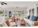 Bright living room featuring hardwood floors, white sofas, blue accents, and a decorative stained glass door at 829 Bayshore Blvd, Tampa, FL 33606
