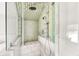 Modern shower with glass enclosure, bench seating, and stylish green and white tiled walls at 829 Bayshore Blvd, Tampa, FL 33606