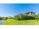 Backyard featuring canal, green lawn, lush landscaping and screened-in lanai at 9226 13Th Avenue Nw Cir, Bradenton, FL 34209