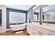 Elegant bathroom featuring a standalone tub, double vanity, and stylish fixtures under natural light at 9226 13Th Avenue Nw Cir, Bradenton, FL 34209