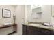 Traditional bathroom with a dark wood vanity, granite countertops, and neutral walls at 9226 13Th Avenue Nw Cir, Bradenton, FL 34209