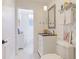 Elegant bathroom featuring a vanity, medicine cabinet, and shower-tub combo with patterned wallpaper at 9226 13Th Avenue Nw Cir, Bradenton, FL 34209