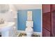 Fun bathroom decor features whimsical tile and blue accent wall at 9226 13Th Avenue Nw Cir, Bradenton, FL 34209