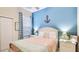 Cozy bedroom featuring nautical decor, a comfortable bed, and abundant natural light at 9226 13Th Avenue Nw Cir, Bradenton, FL 34209