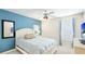 Bright bedroom with a white bed, cool blue accent wall, and light neutral carpet at 9226 13Th Avenue Nw Cir, Bradenton, FL 34209