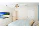 Bedroom with a large TV, a white dresser, and a plush striped comforter at 9226 13Th Avenue Nw Cir, Bradenton, FL 34209