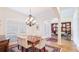 The formal dining room features a chandelier and opens up to a living room with a stylish accent wall at 9226 13Th Avenue Nw Cir, Bradenton, FL 34209