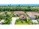 Beautifully landscaped home with a long driveway, large lawn, and well-maintained trees overlooking a tranquil canal at 9226 13Th Avenue Nw Cir, Bradenton, FL 34209
