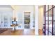 Elegant foyer with light hardwood floors and french doors leading to an outdoor patio at 9226 13Th Avenue Nw Cir, Bradenton, FL 34209