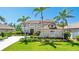 Landscaped lawn of home features mature palms and circular drive at 9226 13Th Avenue Nw Cir, Bradenton, FL 34209
