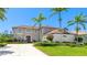 Well maintained home with lush green lawn, mature landscaping, and a circular driveway at 9226 13Th Avenue Nw Cir, Bradenton, FL 34209