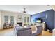 Bright living room with hardwood floors, a fireplace, ceiling fan, and a modern entertainment center at 9226 13Th Avenue Nw Cir, Bradenton, FL 34209