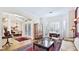 Charming living room featuring elegant decor, hardwood floors, and bright, shuttered windows at 9226 13Th Avenue Nw Cir, Bradenton, FL 34209